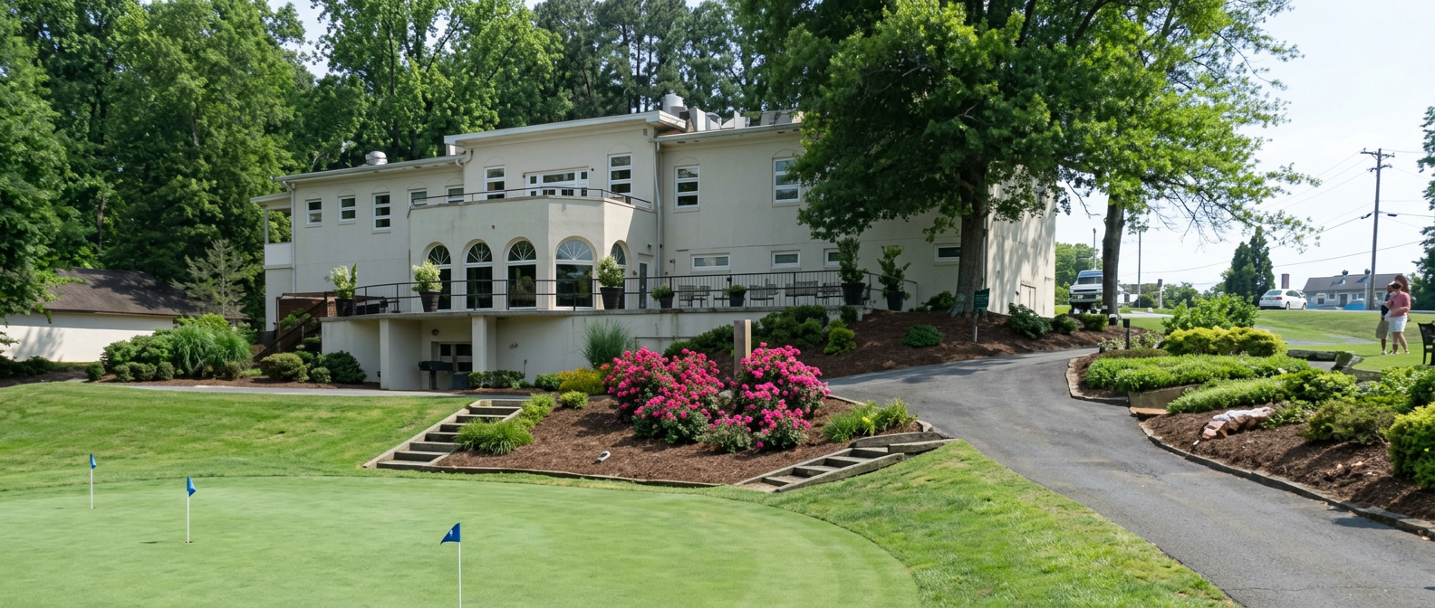 The Halifax Country Club clubhouse with arched windows overlooking the putting green and azaleas
